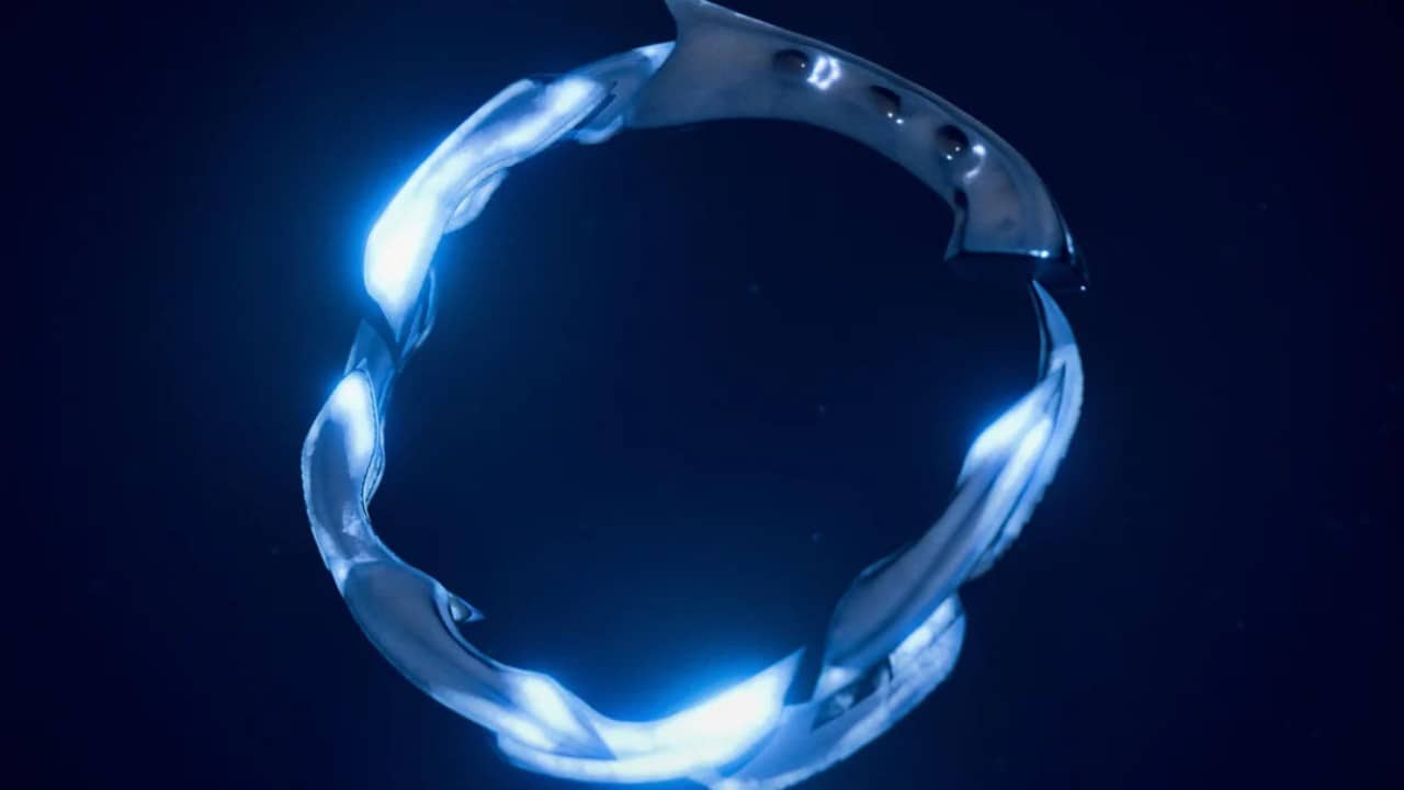 A glowing, metallic ring with twisted design elements against a dark background, reminiscent of an artifact from Helldivers 2.