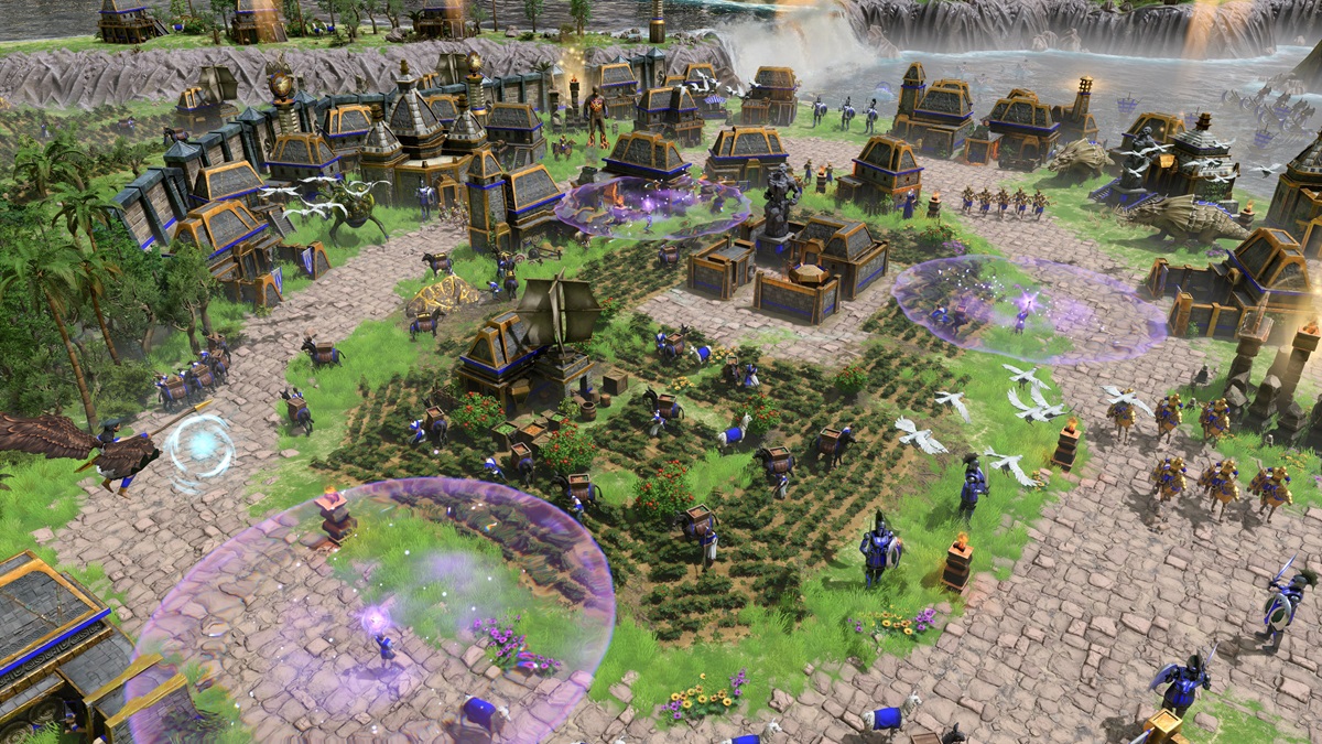 A player builds an Atlantean settlement with villagers and units in Age of Mythology: Retold.