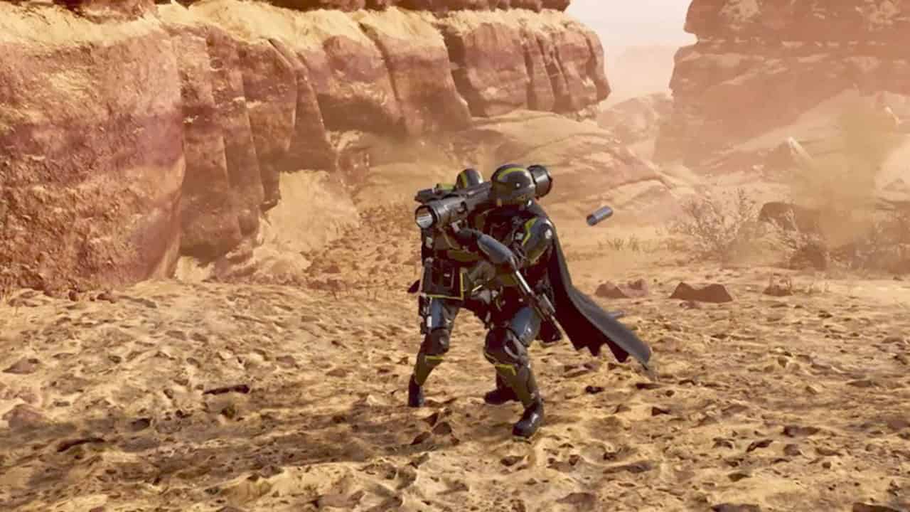 Helldivers 2 Recoilless Rifle: A player gets help from an ally to reload a rocket launcher. Image captured by VideoGamer.