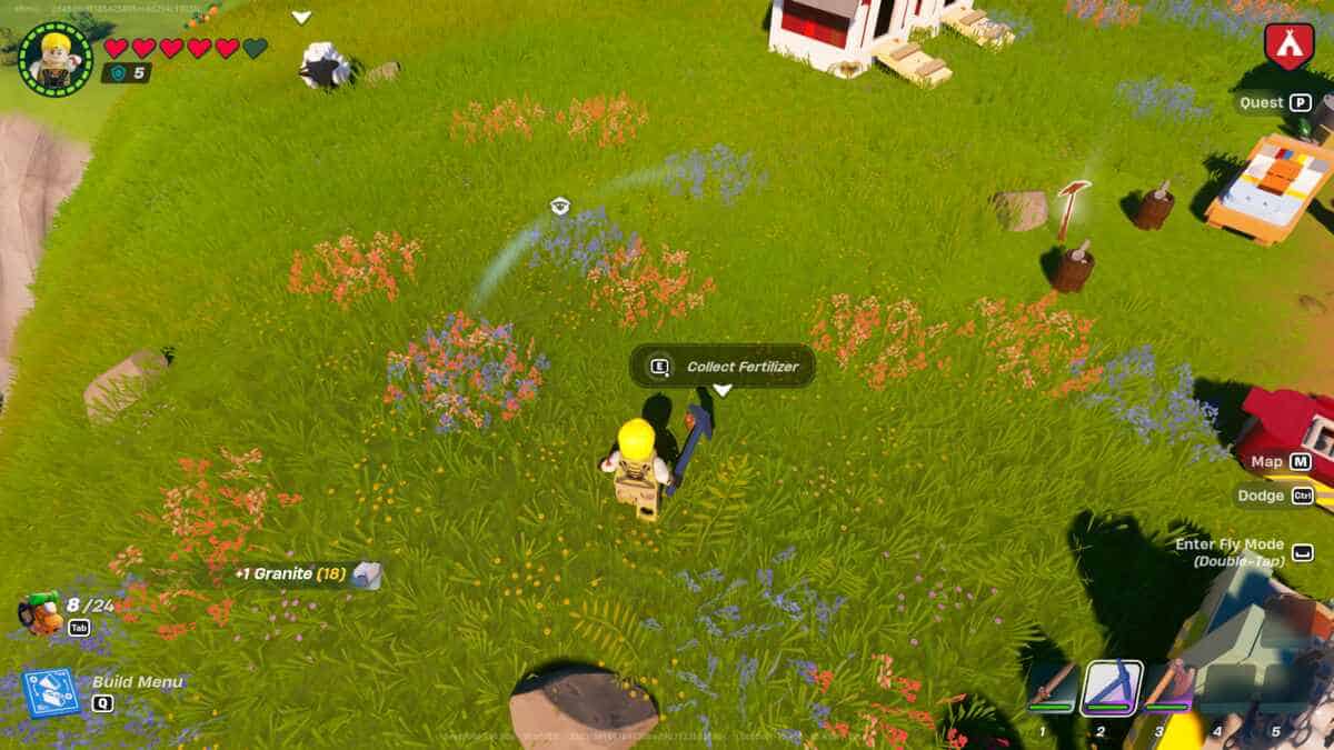 LEGO Fortnite how to get fertilizer: A player standing in a grassy field collecting fertilizer.
