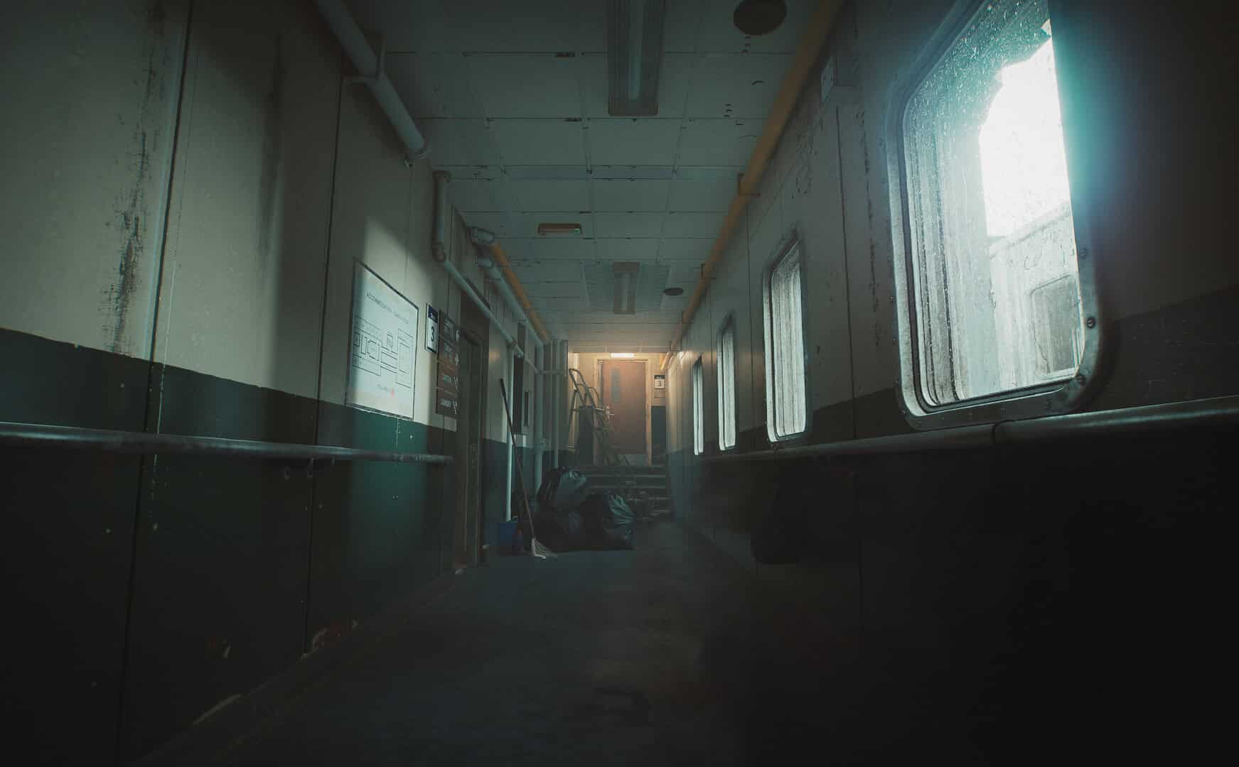 still wakes the deep release date - Dimly lit, narrow hallway with peeling paint and grime
