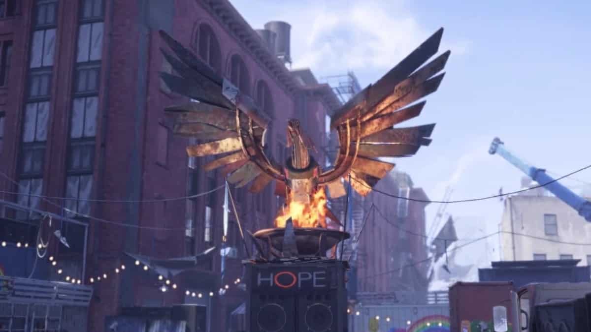 Xdefiant maps: a large, rusted metal phoenix sculpture with outstretched wings stands on a pedestal labeled "HOPE," surrounded by buildings, wires, and lights overhead.