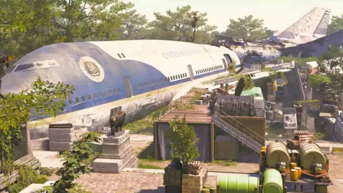 Xdefiant maps: a large, abandoned airplane with the U.S. Presidential Seal and "United States of America" written on it is situated in a deserted area surrounded by trees and various makeshift structures.